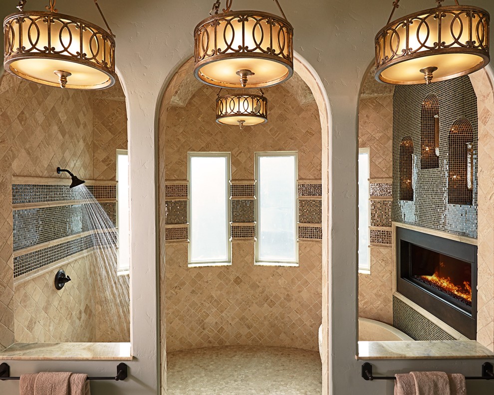 Mediterranean master bathroom in Dallas with raised-panel cabinets, beige cabinets, a freestanding tub, an open shower, a one-piece toilet, multi-coloured tile, limestone, beige walls, porcelain floors, an undermount sink, quartzite benchtops, beige floor, an open shower and beige benchtops.