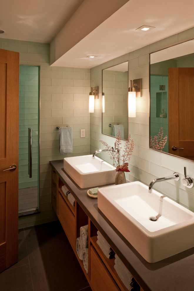 Photo of a large contemporary bathroom in Boston with a vessel sink, flat-panel cabinets, medium wood cabinets, green tile and glass tile.