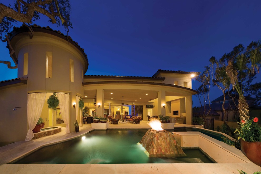 Large contemporary backyard custom-shaped pool in Austin with natural stone pavers.