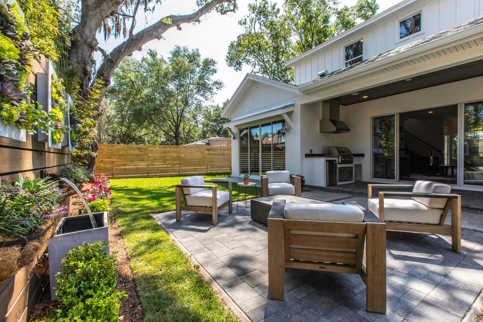 Mid-sized country backyard patio in Orlando with a vertical garden and concrete pavers.