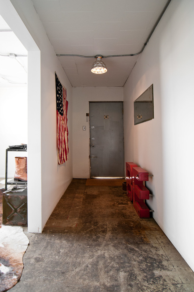 Industrial entryway in Salt Lake City with concrete floors and white walls.