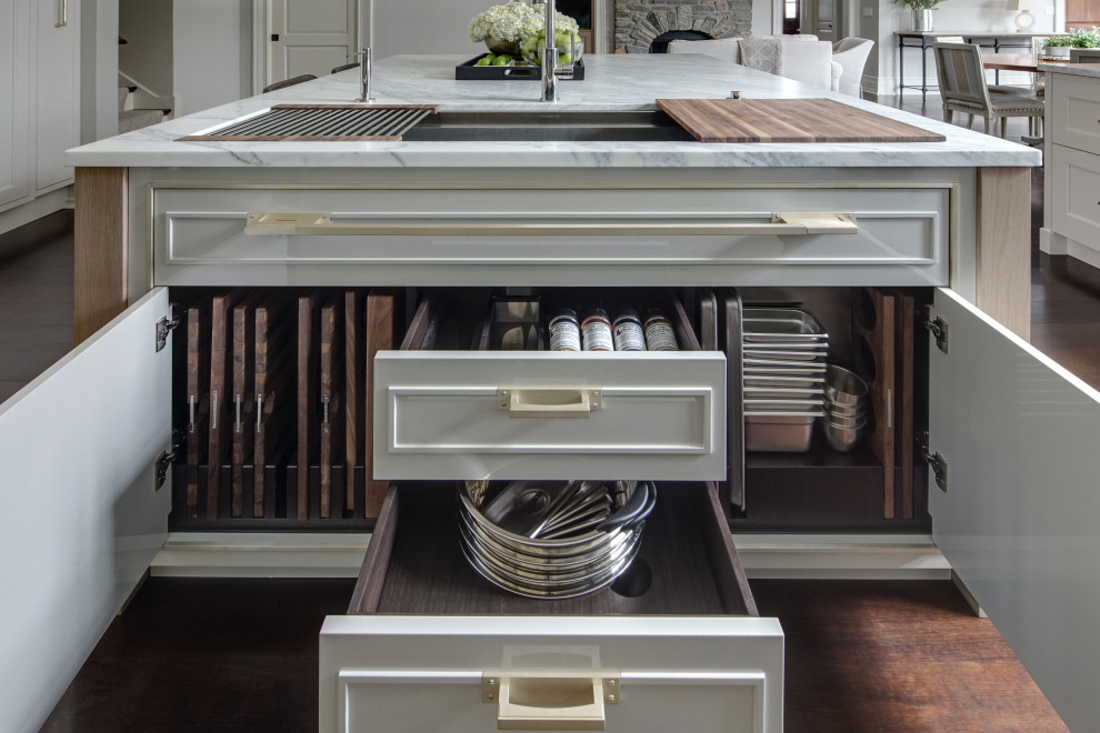Inspiration for a large transitional u-shaped eat-in kitchen in Chicago with an undermount sink, beaded inset cabinets, white cabinets, marble benchtops, white splashback, marble splashback, stainless steel appliances, dark hardwood floors, with island, brown floor, white benchtop and coffered.