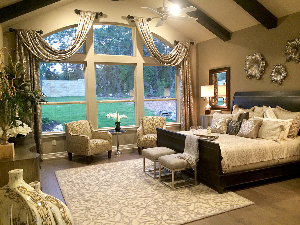 Trendy master medium tone wood floor bedroom photo in Houston with beige walls