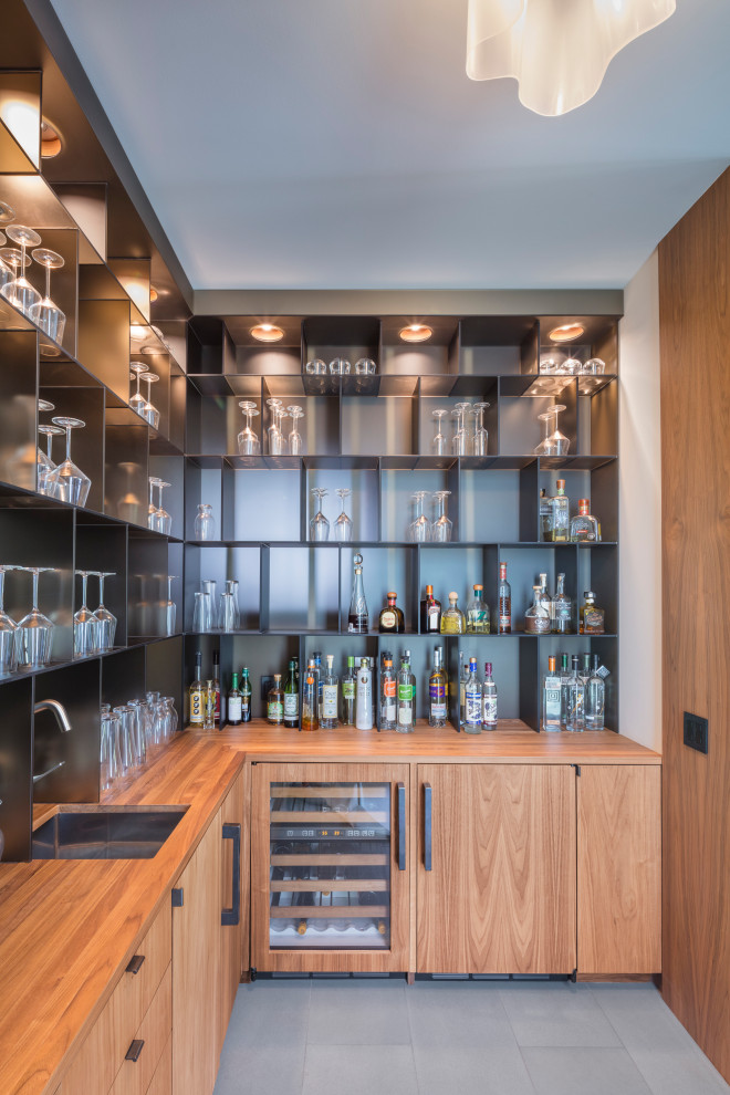 This is an example of a mid-sized contemporary galley wet bar in Detroit with limestone floors and blue floor.