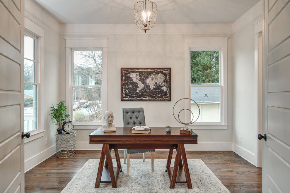 Design ideas for a transitional home office in Atlanta with medium hardwood floors, a freestanding desk, brown floor and white walls.