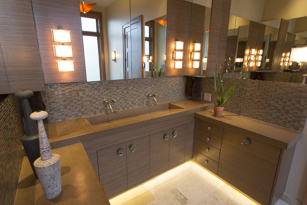 This is an example of a large transitional master bathroom in Seattle with an integrated sink, flat-panel cabinets, medium wood cabinets, concrete benchtops, a freestanding tub, an open shower, a wall-mount toilet, beige tile, glass tile, beige walls and travertine floors.