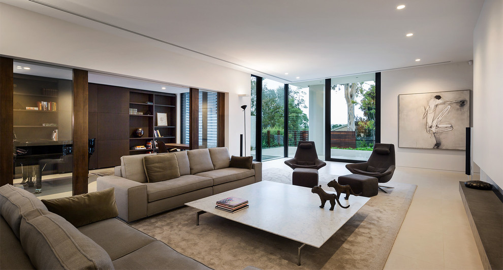 Design ideas for a large contemporary open concept living room in Melbourne with a library, white walls, ceramic floors, a standard fireplace, a plaster fireplace surround and a concealed tv.