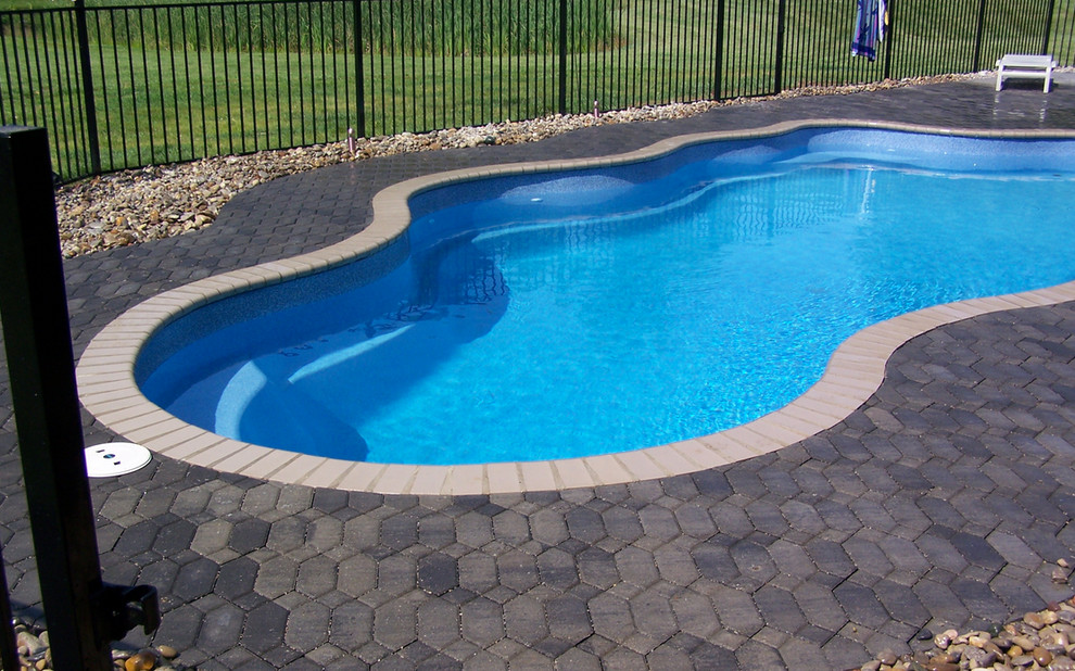 Inspiration for a mid-sized backyard stone and custom-shaped natural pool remodel in Cincinnati
