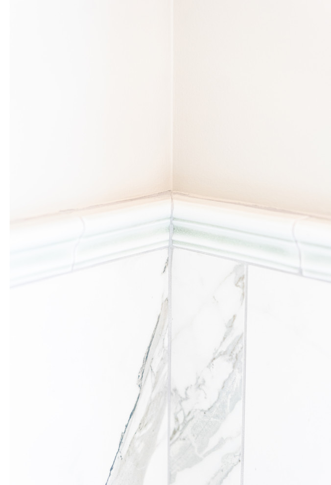 Elegant Bathroom Design Featuring White Marble Tiles and Gold Accents