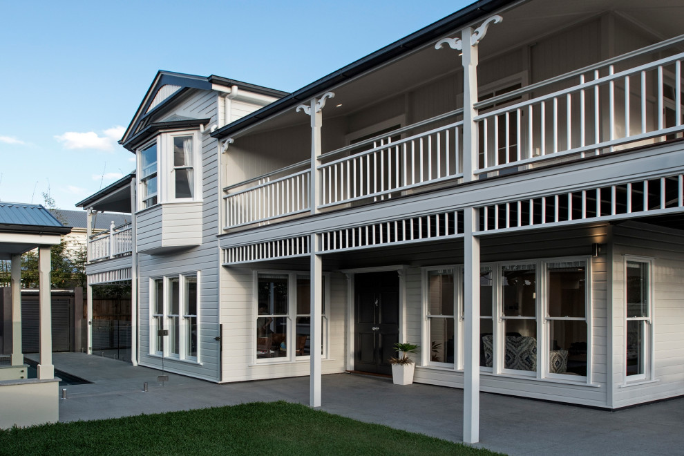 Inspiration for a contemporary two-storey house exterior with mixed siding, a gable roof and a metal roof.