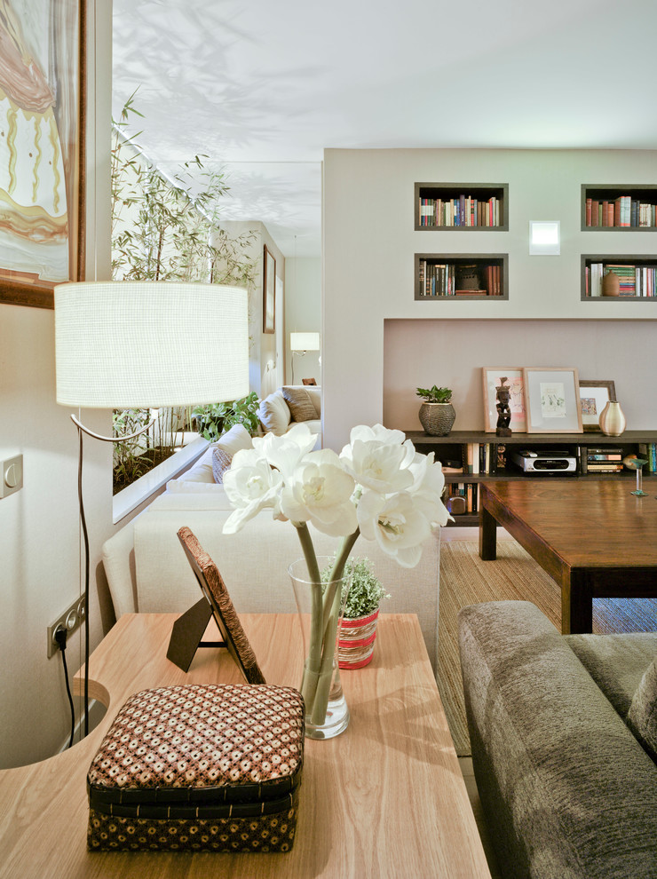 Photo of a modern open concept living room in Other with a library and light hardwood floors.