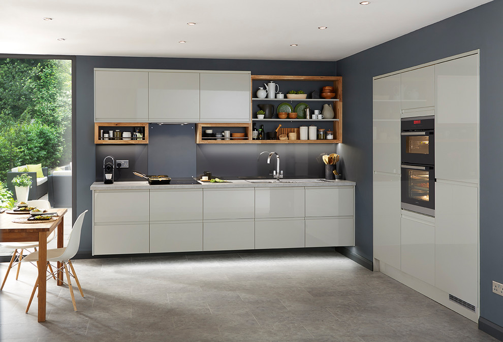 Large contemporary l-shaped eat-in kitchen in Other with flat-panel cabinets, grey cabinets, grey splashback and panelled appliances.