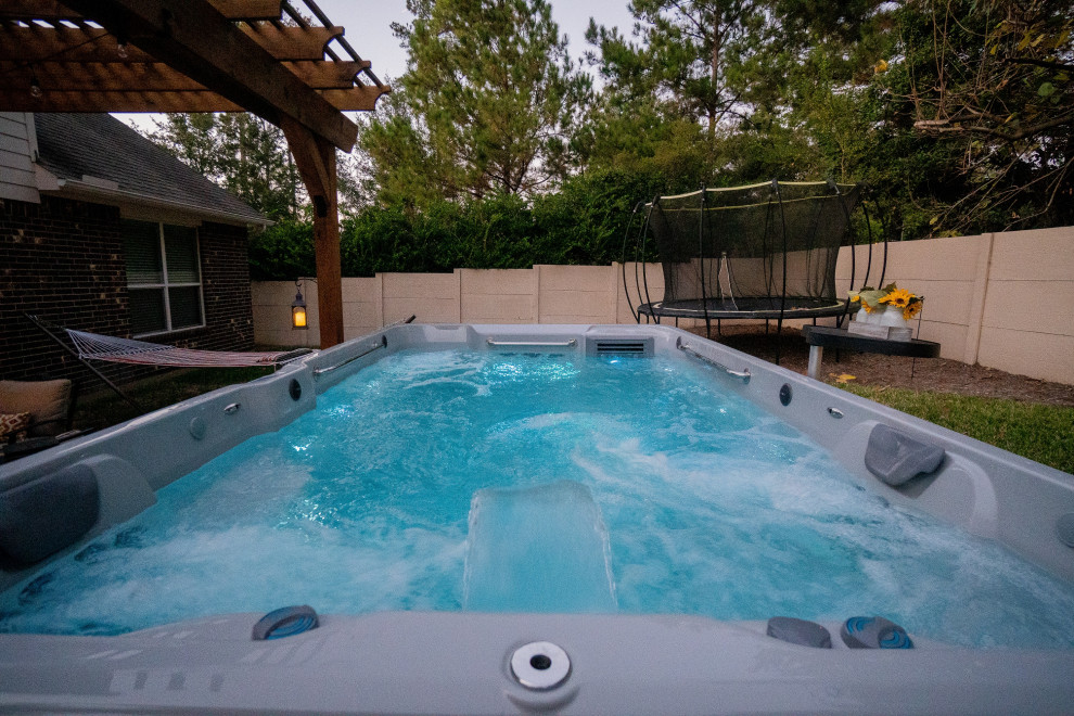 Pool - small modern backyard pool idea in Houston with decking