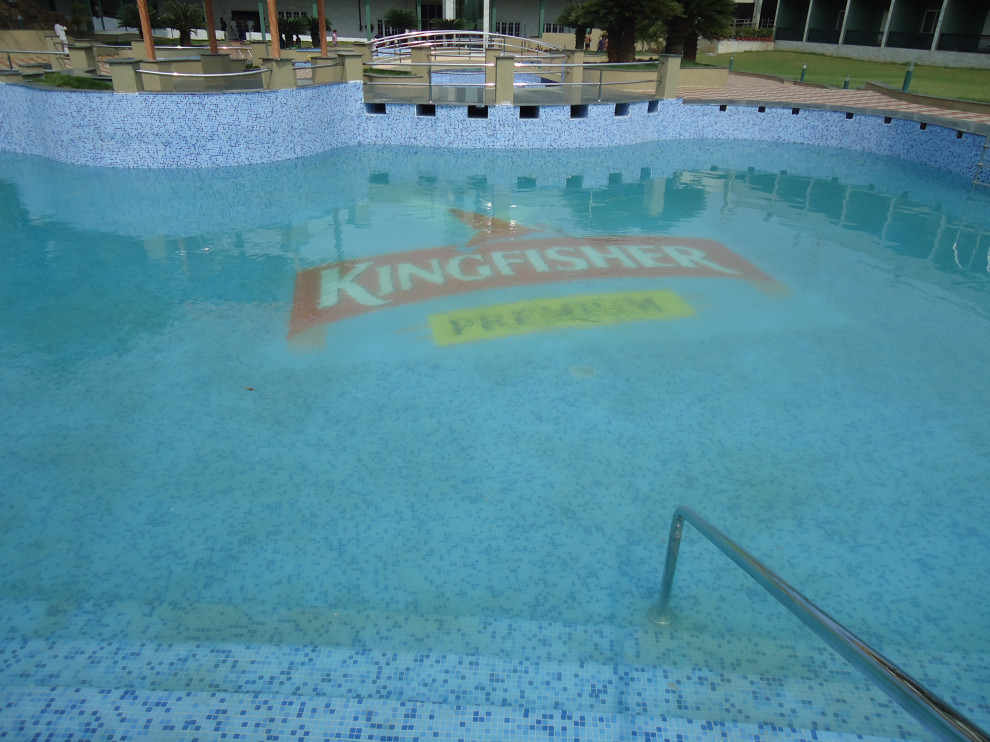 Courtyard tile and custom-shaped pool photo