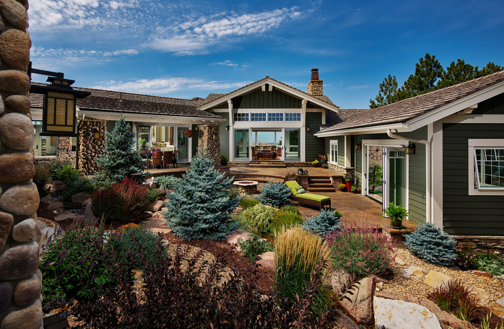 This is an example of an arts and crafts backyard full sun garden in Denver.