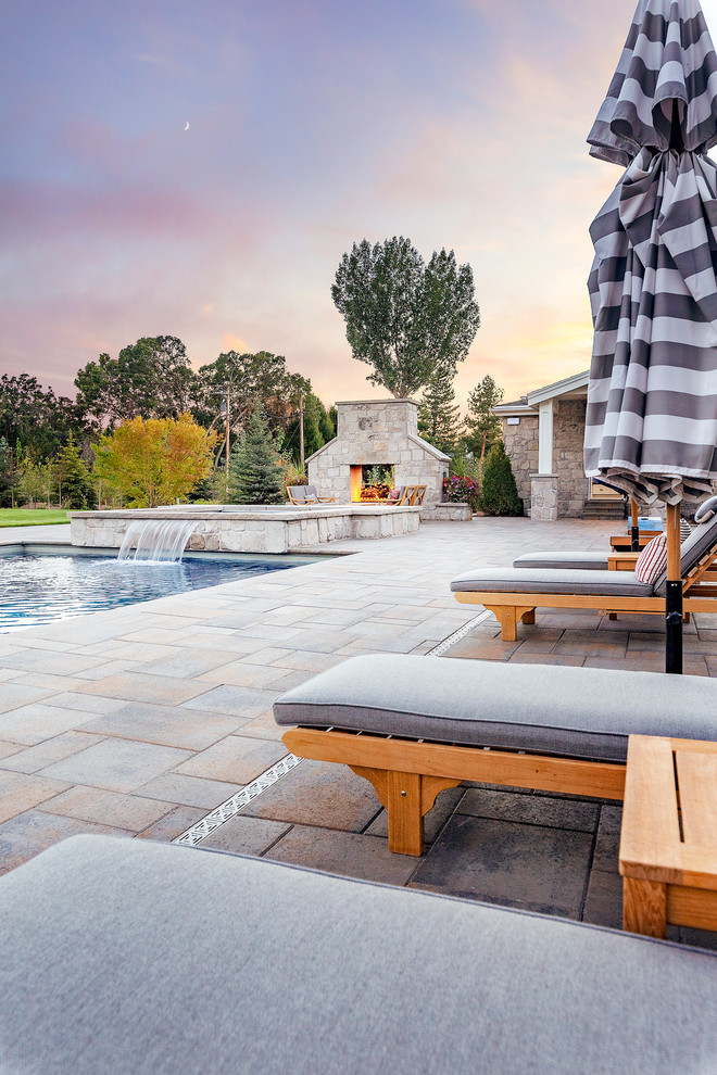 Design ideas for a large traditional backyard rectangular pool in Salt Lake City with a hot tub and concrete pavers.