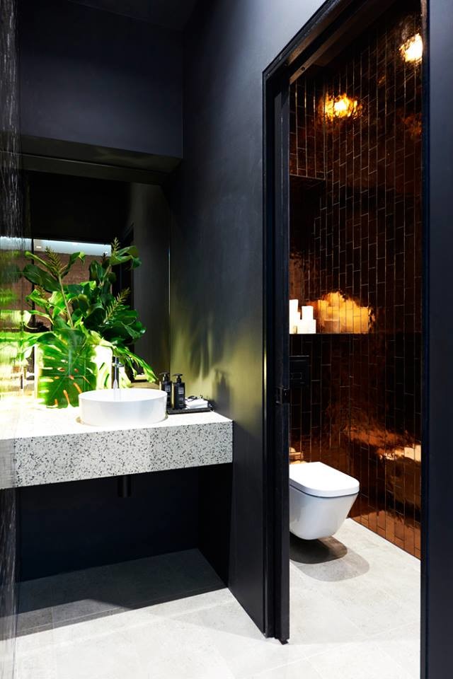 Photo of a mid-sized modern master bathroom in Miami with a one-piece toilet, orange tile, glass tile, grey walls, recycled glass benchtops and a vessel sink.