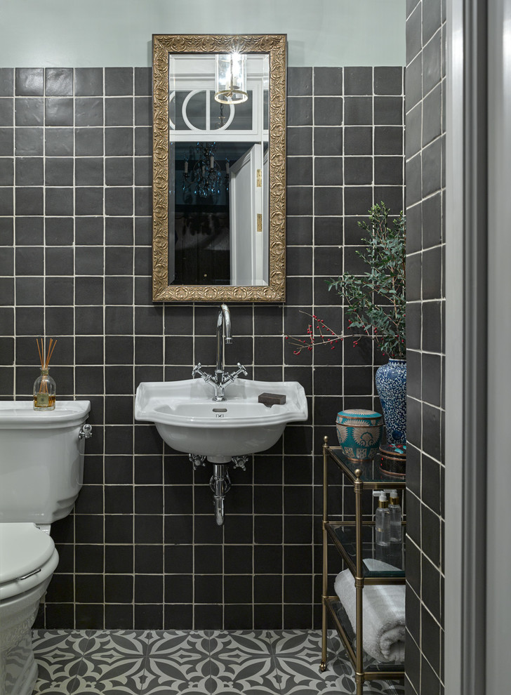 Photo of a transitional powder room in Moscow with a two-piece toilet, black tile, ceramic tile, black walls, a wall-mount sink and multi-coloured floor.