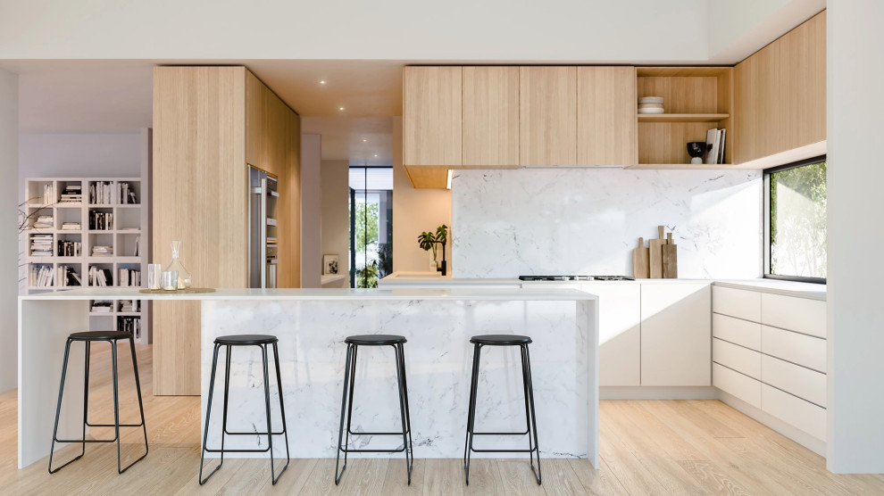Mid-sized contemporary galley open plan kitchen in Perth with an undermount sink, flat-panel cabinets, white cabinets, marble benchtops, white splashback, marble splashback, stainless steel appliances, light hardwood floors, with island, brown floor and white benchtop.