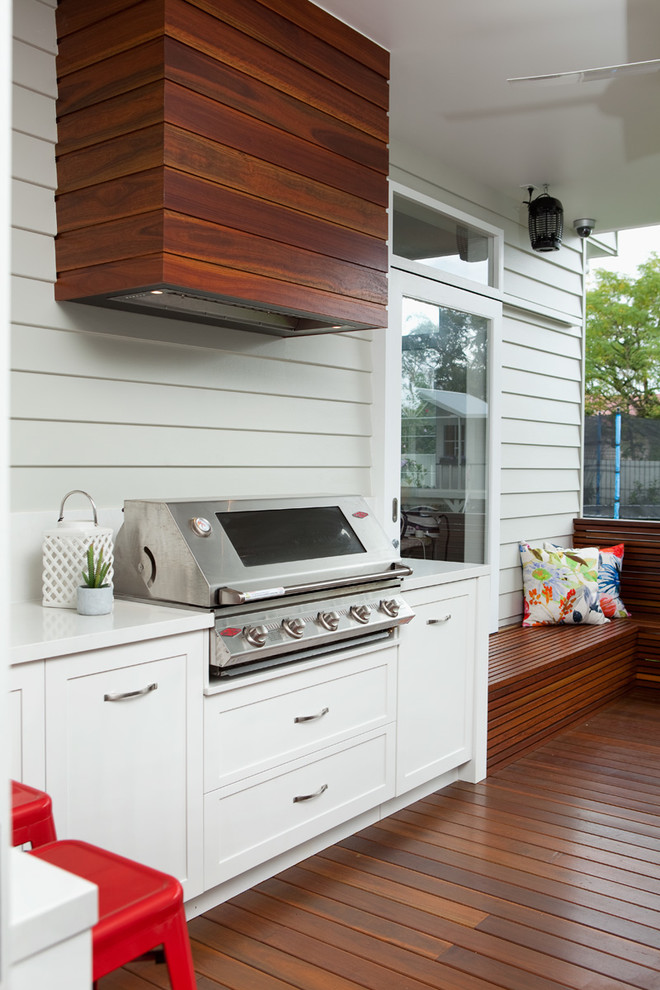 Inspiration for a transitional backyard patio in Brisbane with decking and a roof extension.
