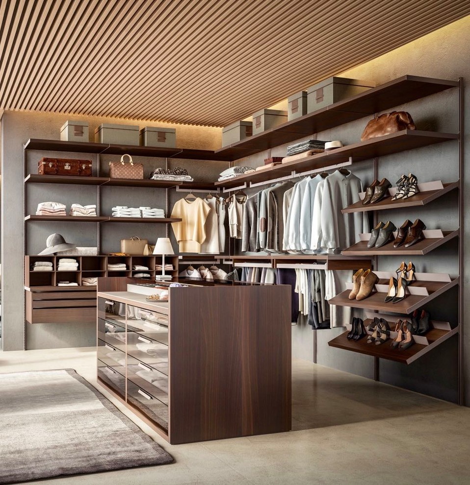 Large contemporary gender-neutral walk-in wardrobe in Miami with open cabinets, brown cabinets, concrete floors and beige floor.