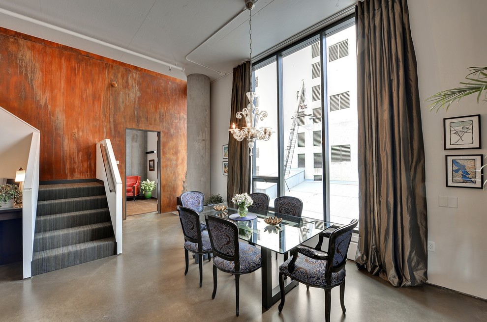 This is an example of a modern dining room in Minneapolis with orange walls.