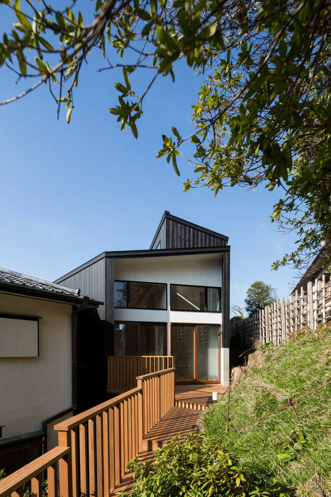 This is an example of a small contemporary black exterior in Other with wood siding and a shed roof.