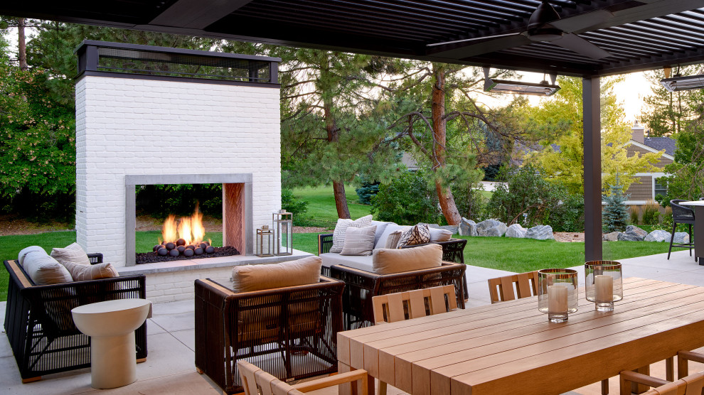 Example of a large transitional backyard patio design in Denver with a fireplace and a pergola