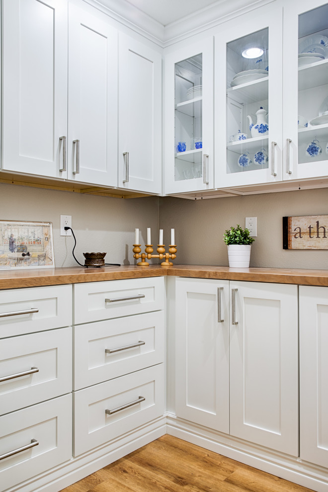 Inspiration for a mid-sized transitional l-shaped laminate floor open concept kitchen remodel in Phoenix with shaker cabinets, white cabinets and wood countertops