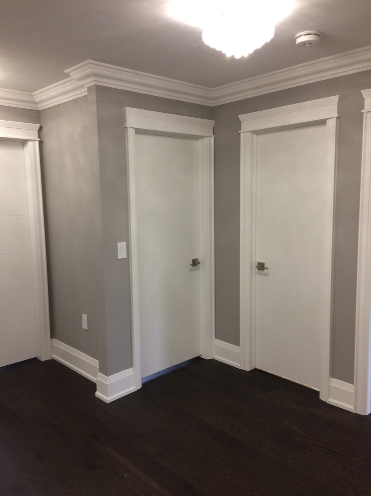 Inspiration for a mid-sized transitional painted wood floor and brown floor hallway remodel in Toronto with gray walls