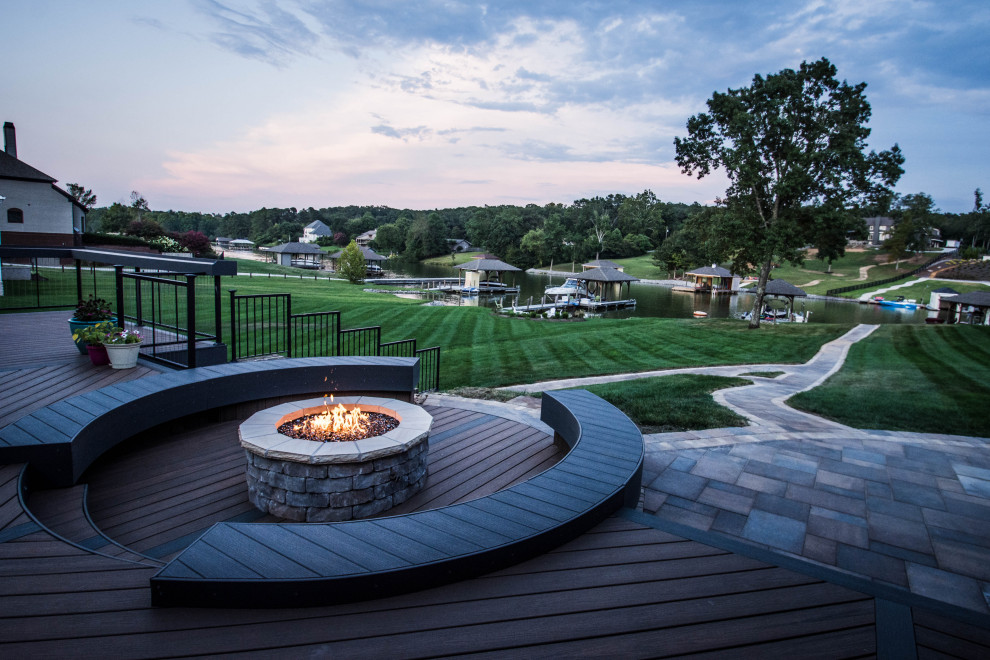 Inspiration for a large transitional backyard deck remodel with a fire pit and no cover