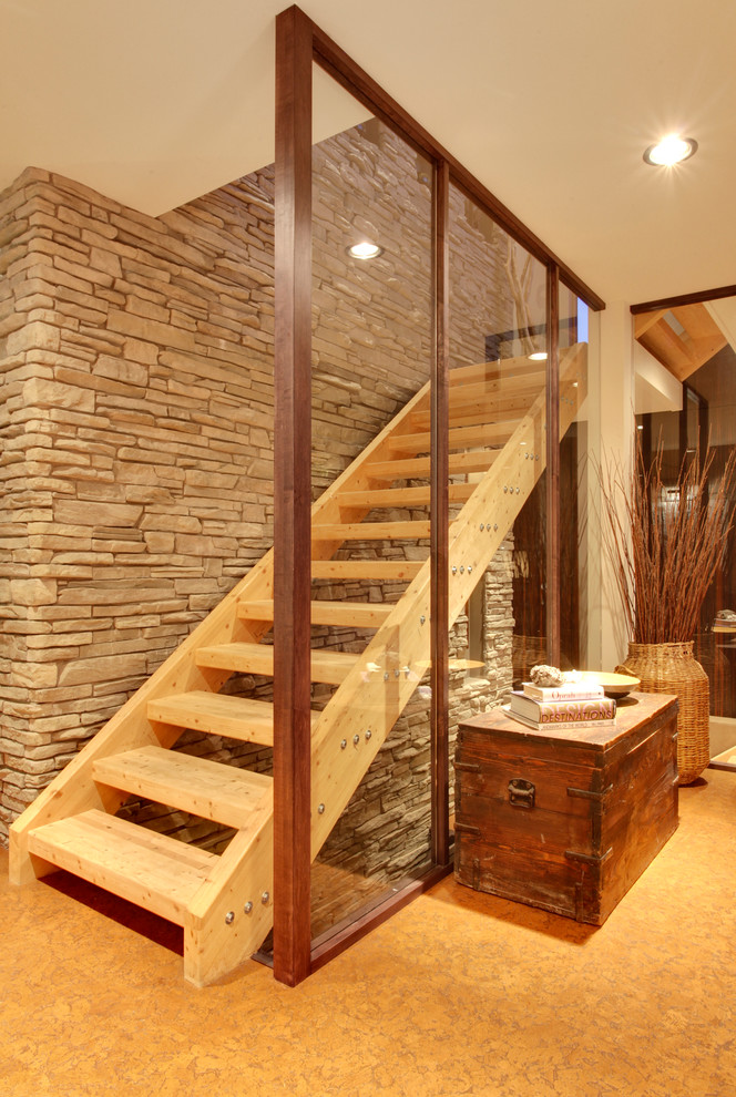 Contemporary wood staircase in Calgary with open risers and feature lighting.