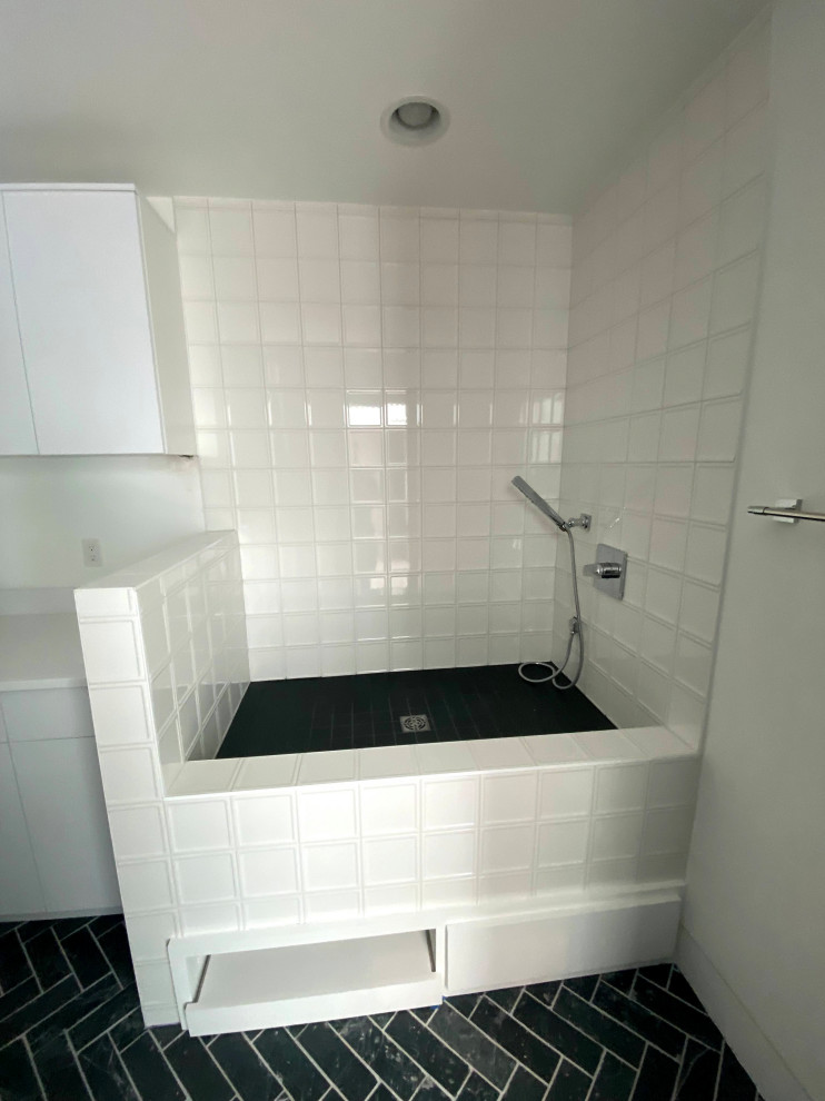 Photo of a large modern shower room bathroom in Other with flat-panel cabinets, white cabinets, a corner bath, white walls, ceramic flooring, a built-in sink, grey floors, white worktops, a single sink and a built in vanity unit.