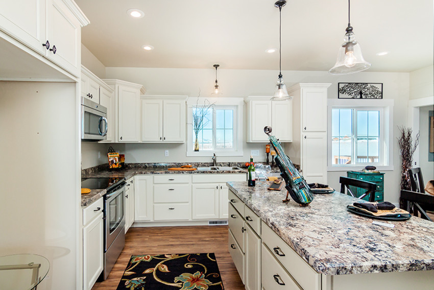 Open concept kitchen - mid-sized transitional l-shaped medium tone wood floor open concept kitchen idea with an undermount sink, recessed-panel cabinets, white cabinets, granite countertops, stainless steel appliances and an island