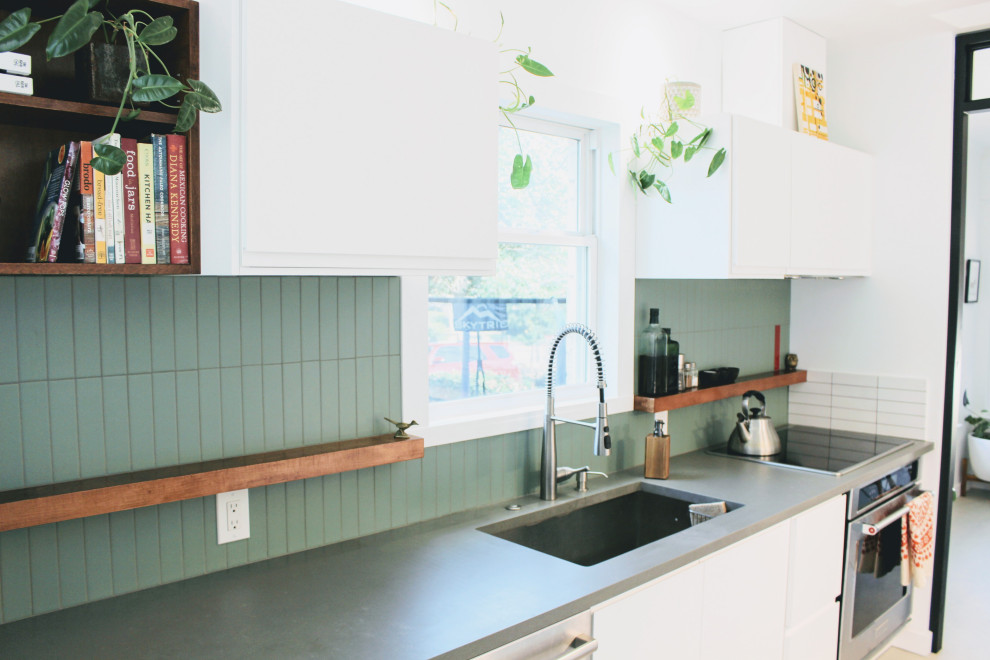 На фото: маленькая кухня в стиле фьюжн с зеленым фартуком, фартуком из керамической плитки и техникой из нержавеющей стали для на участке и в саду