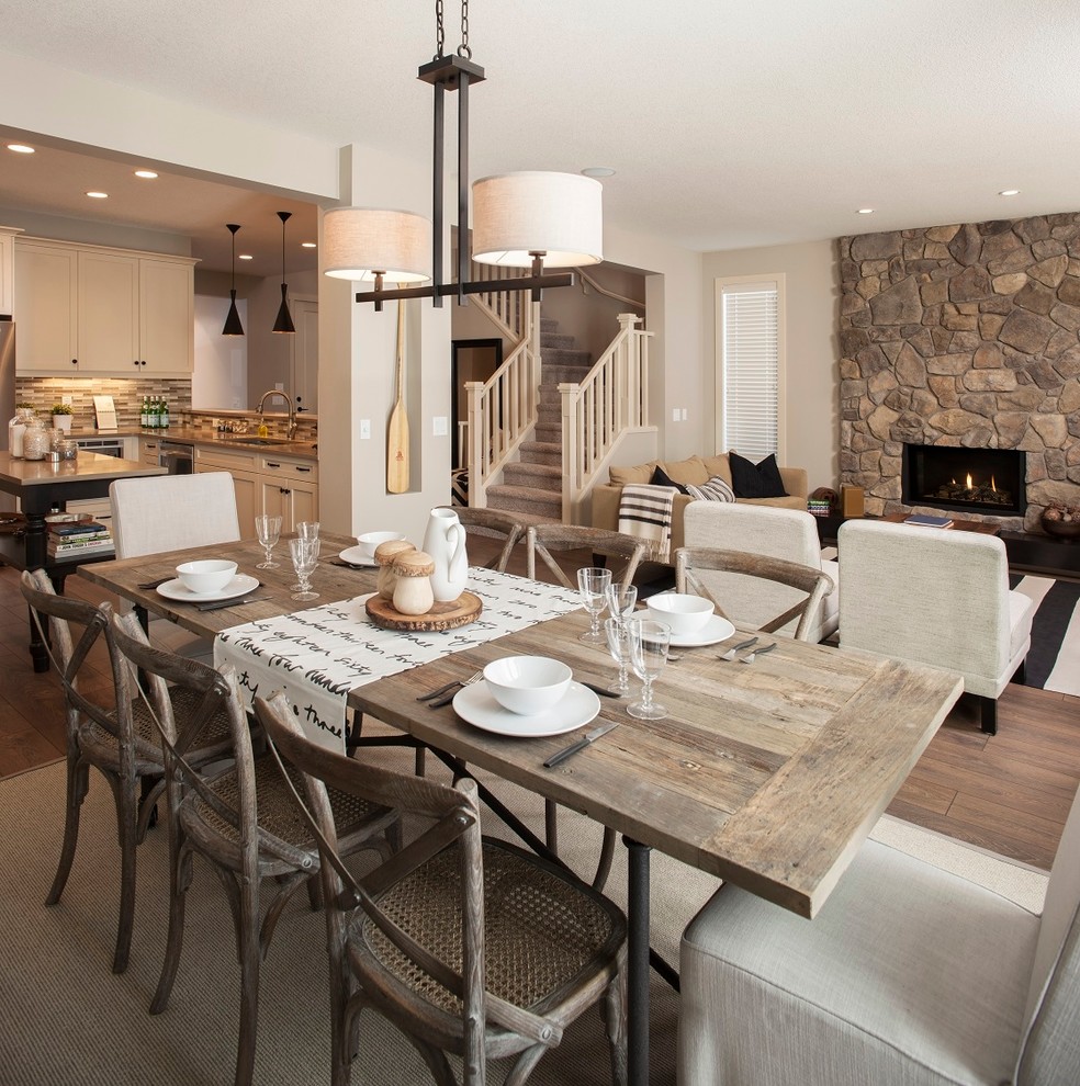 Traditional open plan dining in Edmonton with beige walls, dark hardwood floors and brown floor.