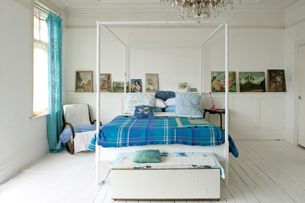 Design ideas for a traditional bedroom in London with white walls and painted wood floors.