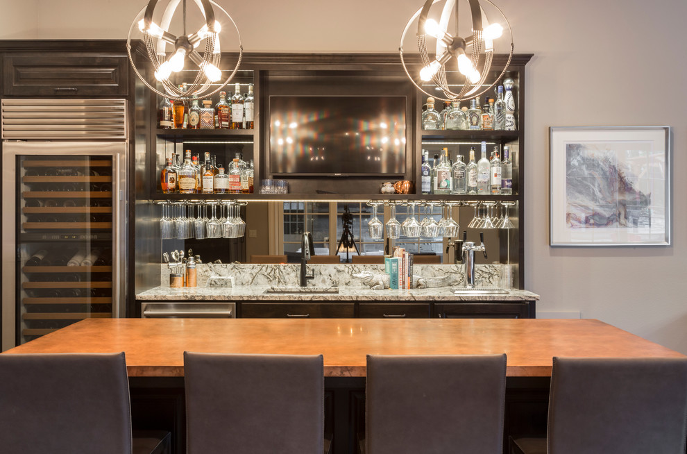 Inspiration for an expansive transitional galley seated home bar in Portland with an undermount sink, beaded inset cabinets, dark wood cabinets, quartz benchtops, mirror splashback, medium hardwood floors and multi-coloured benchtop.