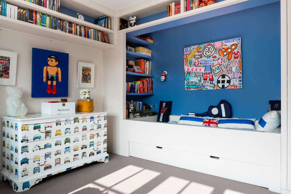 Photo of a contemporary kids' bedroom for kids 4-10 years old and boys in London with blue walls and carpet.