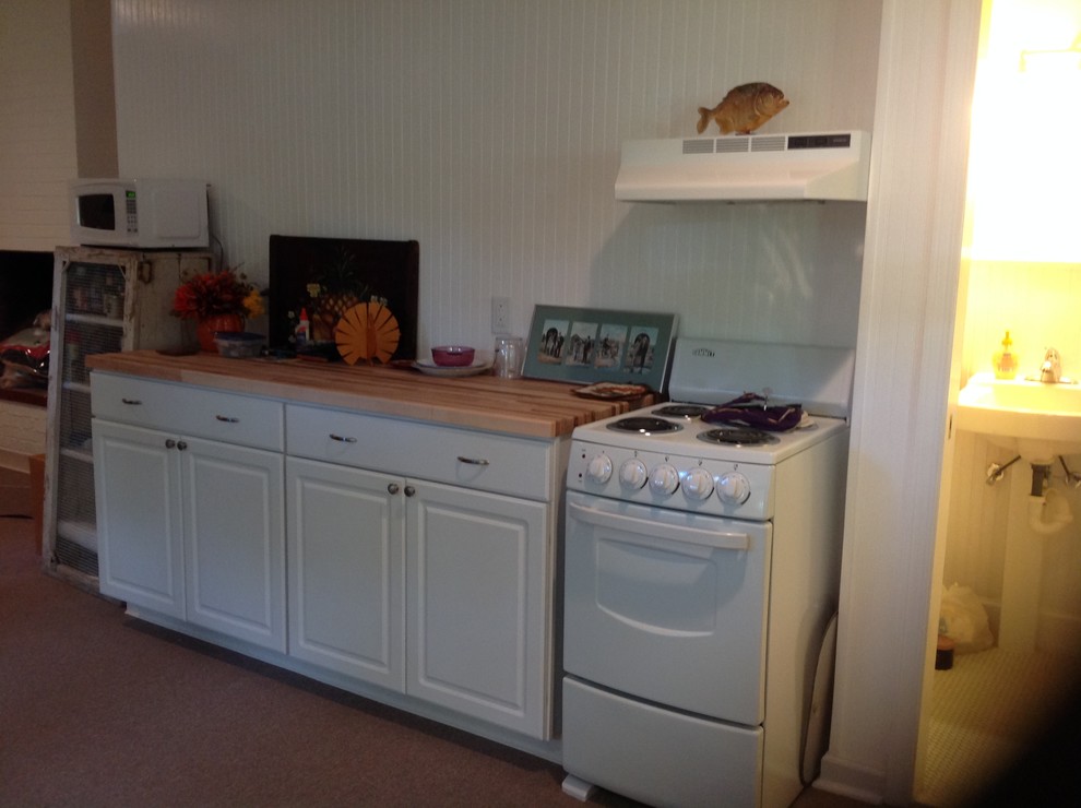 Example of a small transitional look-out light wood floor basement design with yellow walls