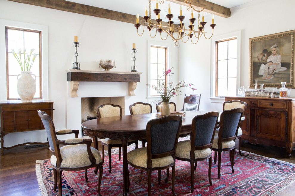 Mediterranean dining room in San Francisco with white walls, dark hardwood floors and a standard fireplace.