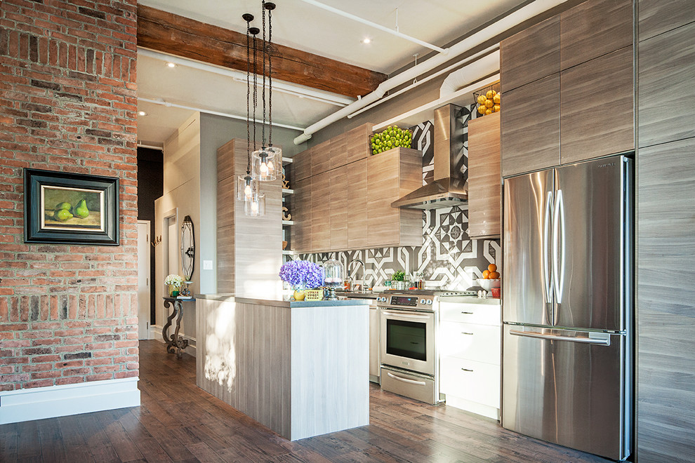 Mid-sized contemporary single-wall open plan kitchen in Toronto with flat-panel cabinets, medium wood cabinets, multi-coloured splashback, stainless steel appliances, medium hardwood floors, with island and brown floor.