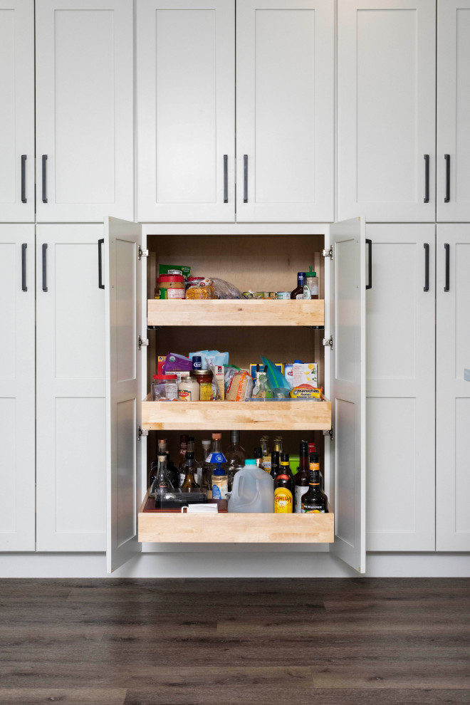 Inspiration for a large transitional vinyl floor and brown floor kitchen pantry remodel in Orlando with an undermount sink, shaker cabinets, white cabinets, quartzite countertops, multicolored backsplash, porcelain backsplash, stainless steel appliances, an island and white countertops