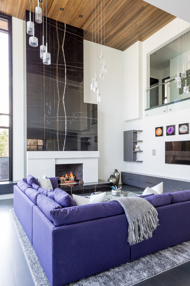 Contemporary open concept living room in Toronto with white walls, dark hardwood floors, a standard fireplace and a wall-mounted tv.