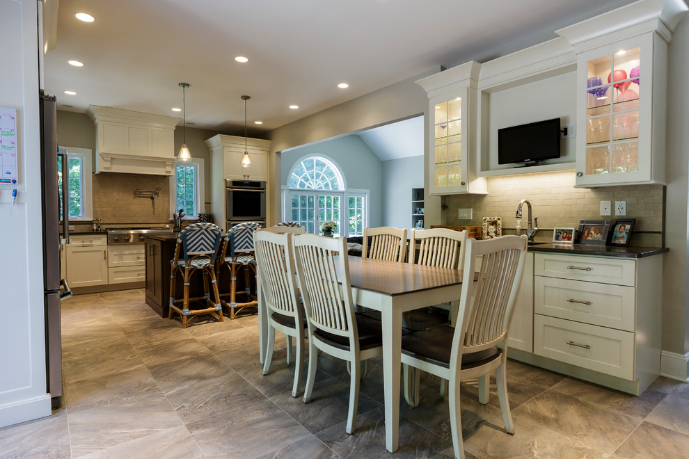 Mid-sized mountain style l-shaped porcelain tile and beige floor open concept kitchen photo in Bridgeport with an undermount sink, shaker cabinets, white cabinets, granite countertops, beige backsplash, porcelain backsplash, stainless steel appliances and an island