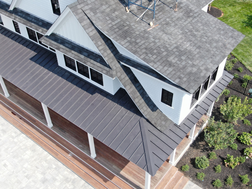 Inspiration for an expansive contemporary three-storey white house exterior in Bridgeport with wood siding, a gable roof, a mixed roof, a black roof and board and batten siding.