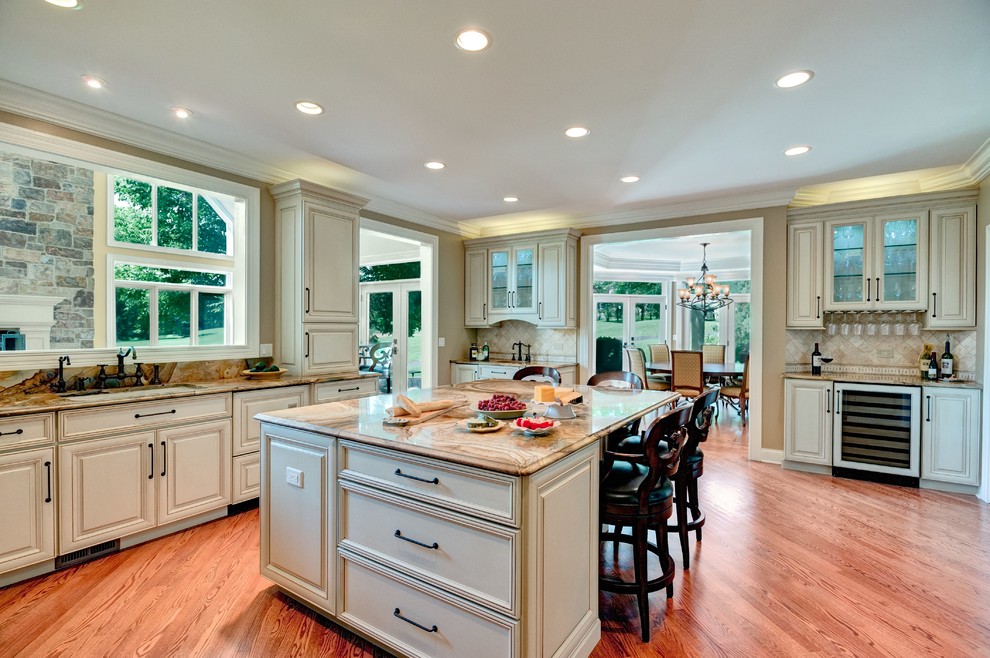 Inspiration for an expansive traditional kitchen in Chicago with raised-panel cabinets, beige cabinets and with island.