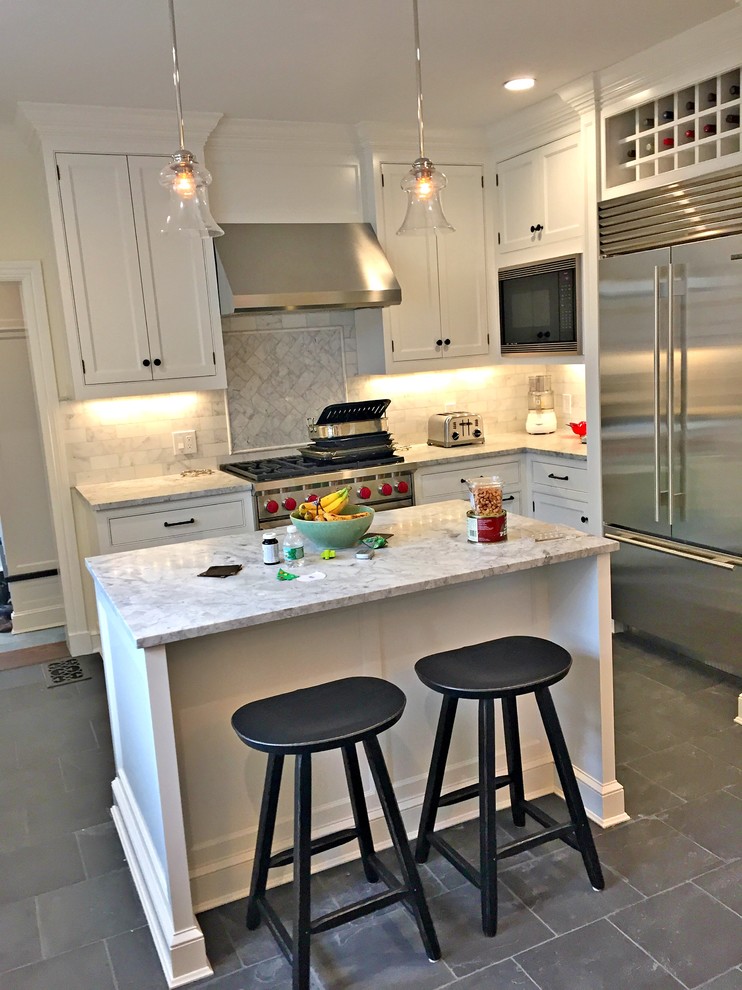 This is an example of a transitional kitchen in Other with beaded inset cabinets, white cabinets, stainless steel appliances and with island.