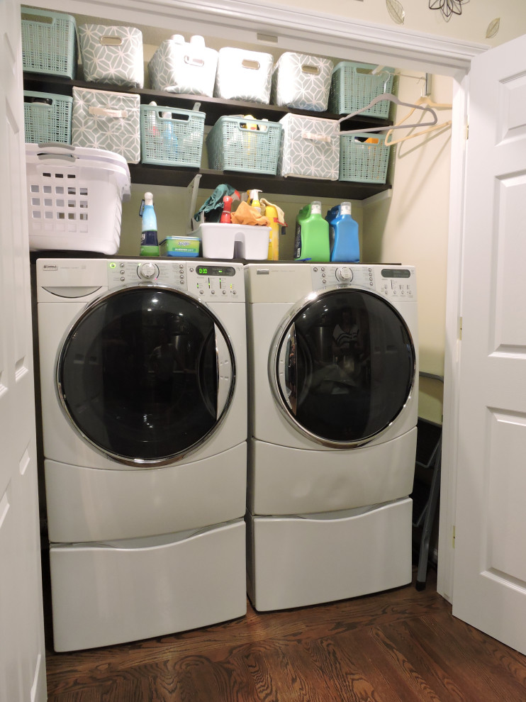 Inspiration for a small contemporary laundry cupboard in Other with beige walls, medium hardwood floors, a side-by-side washer and dryer and brown floor.