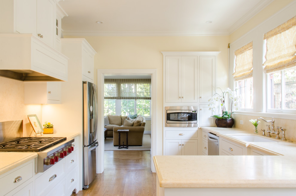 Inspiration for a small traditional kitchen in San Francisco with an undermount sink, white cabinets and a peninsula.